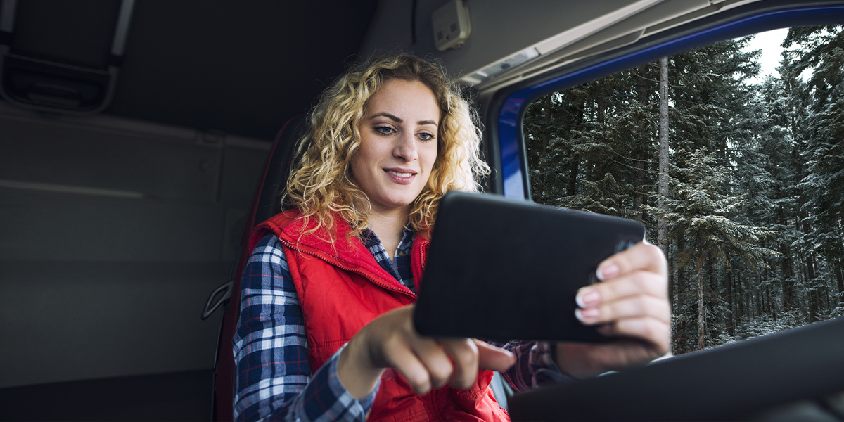 Woman using RV Wi-Fi inside a camper van